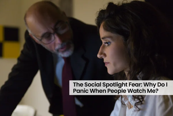 Person looking worried at their phone while sitting apart from their partner, showing trust crack in relationships